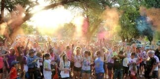 Crowd Of Runners Throwing Powder Paint Into Air