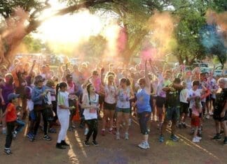 Crowd Of Runners Throwing Powder Paint Into Air