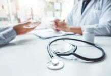 Medicare High Deductible G Plan vs. Advantage PPO Doctors And Patients Consulting And Diagnostic Examining Sit And Talk. At The Table Near The Window In The Hospital Medicine Concept
