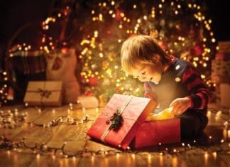Christmas Child Open Present Gift, Happy Baby Boy Looking To Magic Light In Box, Kid And Xmas Tree
