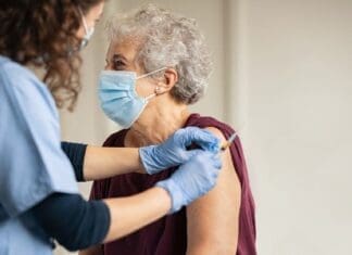 Doctor Giving Covid Vaccine To Senior Woman