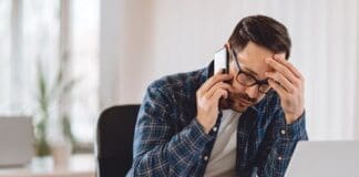Worried Businessman Talking On Phone