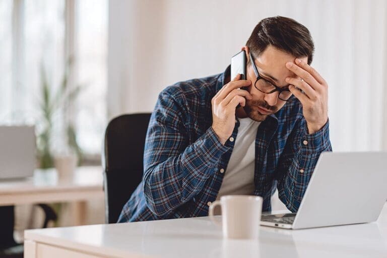 Worried Businessman Talking On Phone