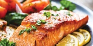 Barbecued Salmon, Fried Potatoes And Vegetables On Wooden Background