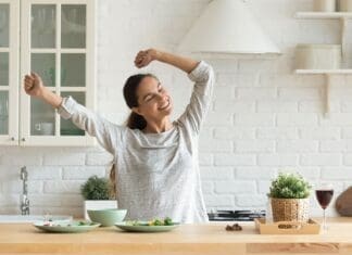 Happy Millennial Woman Have Fun Cooking Breakfast In Kitchen