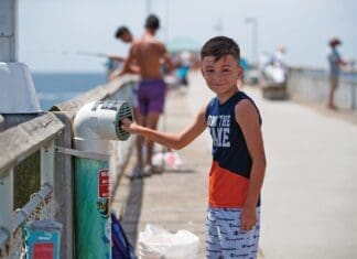 Young Angler Recylces Fishing Line In One Cba S Recycling Bins Located On Okaloosa Island Pier.