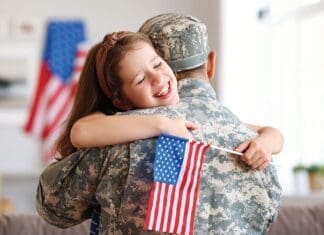 Happy Girl Daughter With American Flag Hugging Father Came Back From Us Army