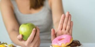 Dieting Or Good Health Concept. Young Woman Rejecting Junk Food Or Unhealthy Food Such As Donut Or Dessert And Choosing Healthy Food Such As Fresh Fruit Or Vegetable.