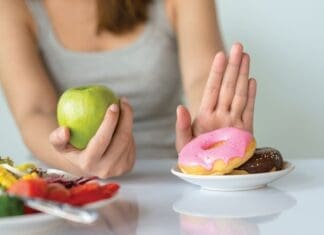 Dieting Or Good Health Concept. Young Woman Rejecting Junk Food Or Unhealthy Food Such As Donut Or Dessert And Choosing Healthy Food Such As Fresh Fruit Or Vegetable.