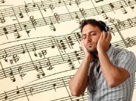 Young Man Listens To Music With Headphones