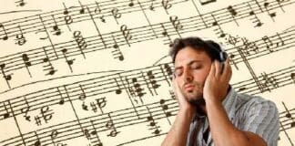 Young Man Listens To Music With Headphones