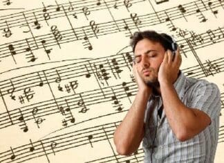 Young Man Listens To Music With Headphones