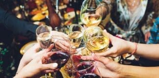 Champagne Glasses In Hands Of People At Party.