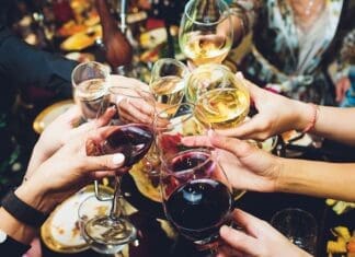 Champagne Glasses In Hands Of People At Party.