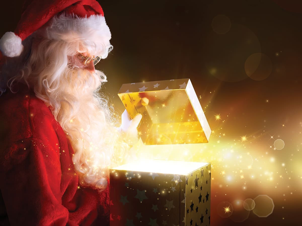 Santa Claus Opening Christmas Present With Shiny Stars
