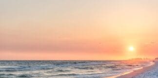 Dreamy Pink Peach Orange Sunset In Santa Rosa Beach, Florida With Pensacola Coastline Coast Cityscape Skyline In Panhandle With Ocean Gulf Mexico Waves, Birds