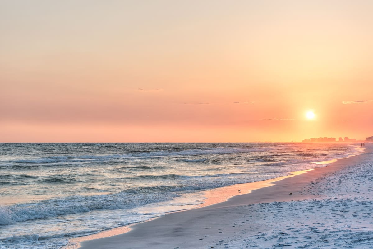 Dreamy Pink Peach Orange Sunset In Santa Rosa Beach, Florida With Pensacola Coastline Coast Cityscape Skyline In Panhandle With Ocean Gulf Mexico Waves, Birds