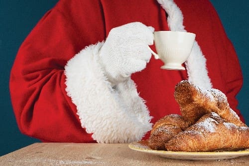 Beakfast Of Santa Claus. Santa Drinking Coffee And Eating Croissants. Close Up View.