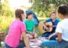 Group Of Children Resting At Summer Camp