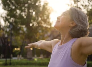 Calm the Chaos: Understanding Cortisol and How to Take Back Control of Your Health Asia Adult Aged People Middle Age Mindful Happy Old Woman Open Arm Yoga Deep Calm Stress Relief Outdoor Nature Public Park Sun Light Self Love Relax Elder Aging Life Asian Female Mental Health Care.