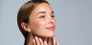 Gorgeous, Young Woman With Clean, Fresh Skin Is Touching The Face. Light Smile On The Perfect Face. Cosmetology Manicure.