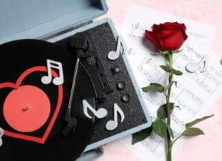 Composition,with,rose,flower,,record,player,,sheet,notes,and,decorative