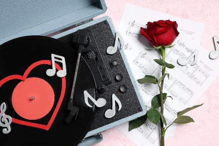 Composition,with,rose,flower,,record,player,,sheet,notes,and,decorative