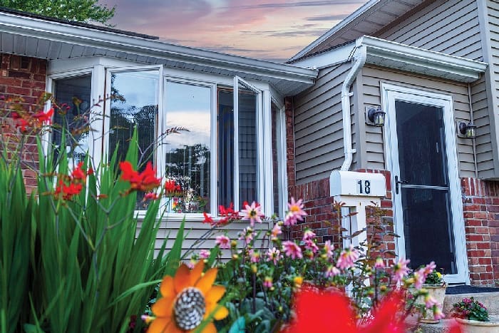 Front Of House With Natural Light With Flowers