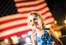 Events Baytowne Girl In Front Of Flag