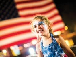 Events Baytowne Girl In Front Of Flag