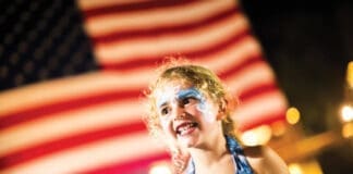 Events Baytowne Girl In Front Of Flag
