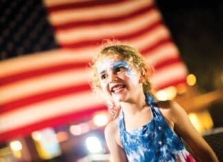 Events Baytowne Girl In Front Of Flag