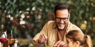 Father And Daughter Laughing Over Lunch At Outdoor Restaurant Patio, Family Dining And Bonding