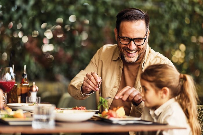 Father And Daughter Laughing Over Lunch At Outdoor Restaurant Patio, Family Dining And Bonding
